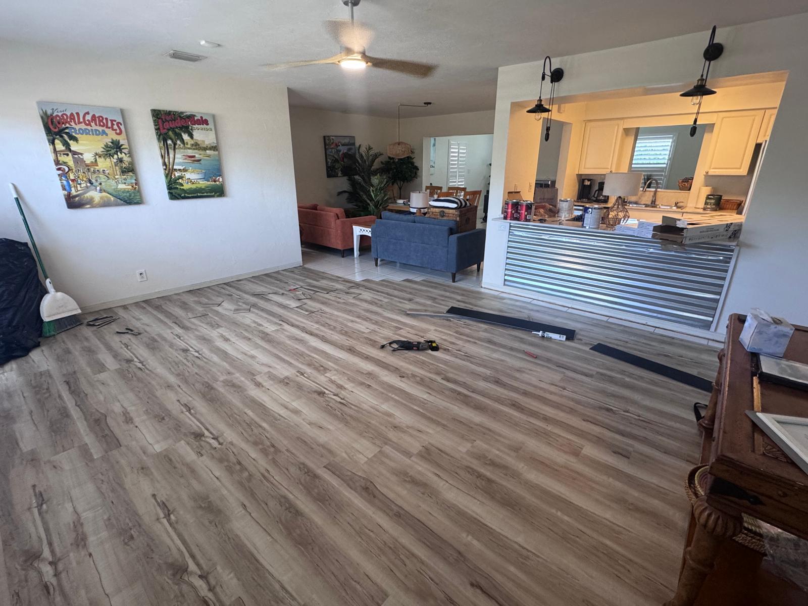 Finished living room with warm wood-look LVP and Florida coastal decor