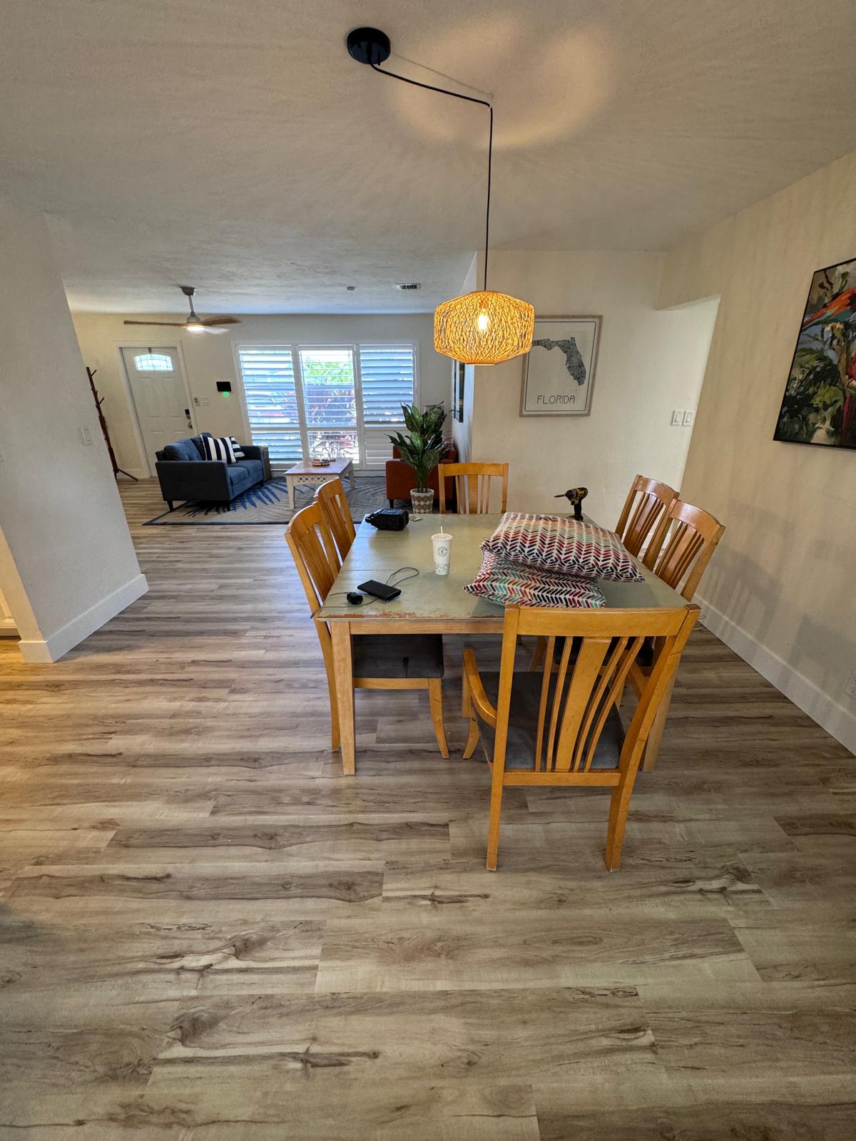 Open dining and living area with warm LVP throughout