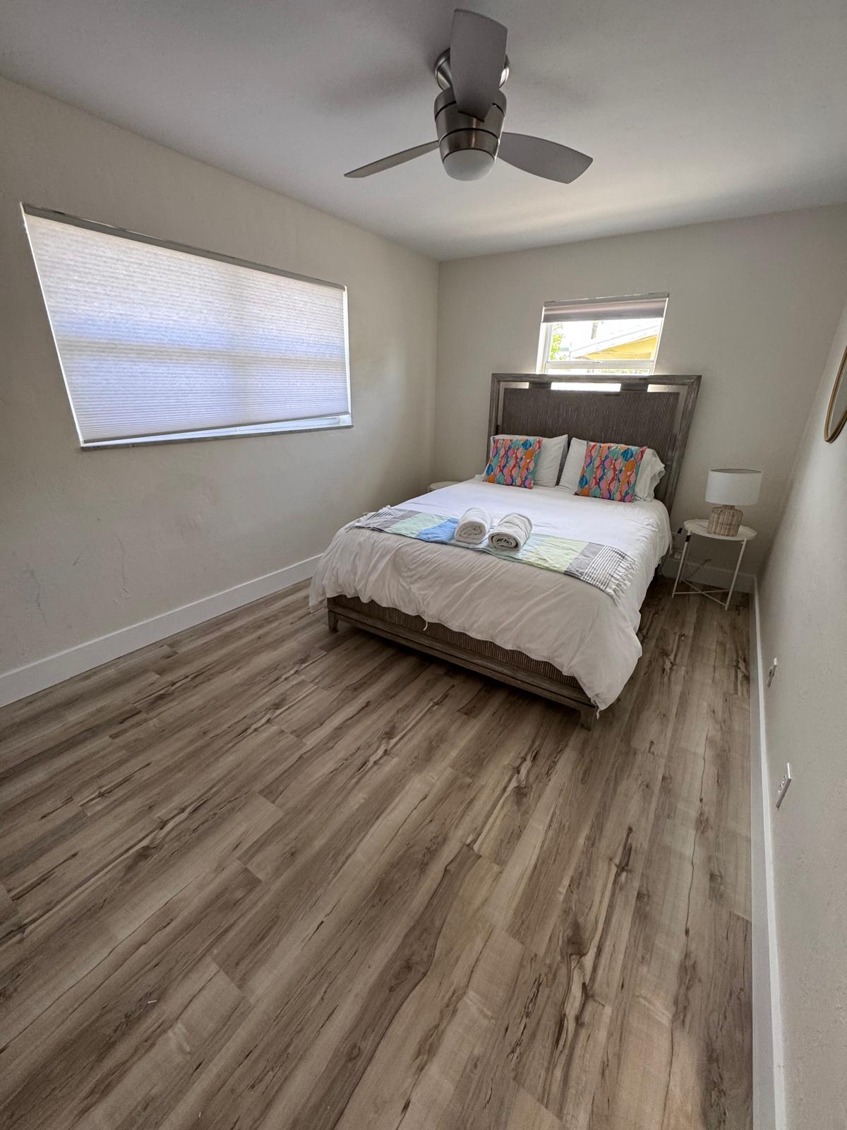 Bedroom with new wide-plank LVP and minimalist styling
