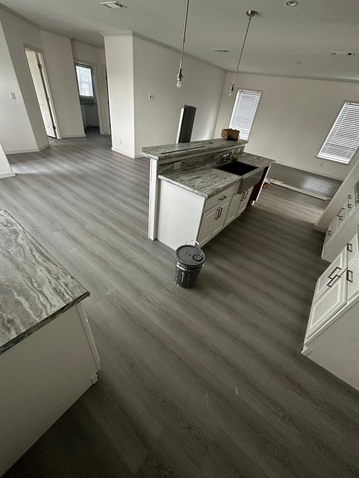 Open-concept kitchen and living area finished with new luxury vinyl plank