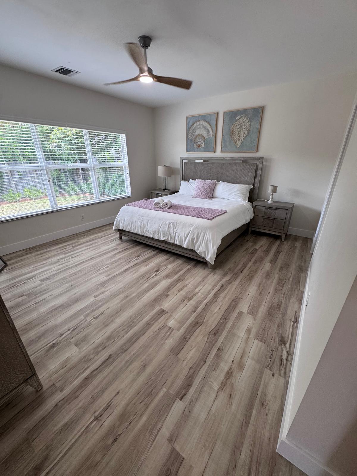 Master bedroom transformation with light grey LVP flooring