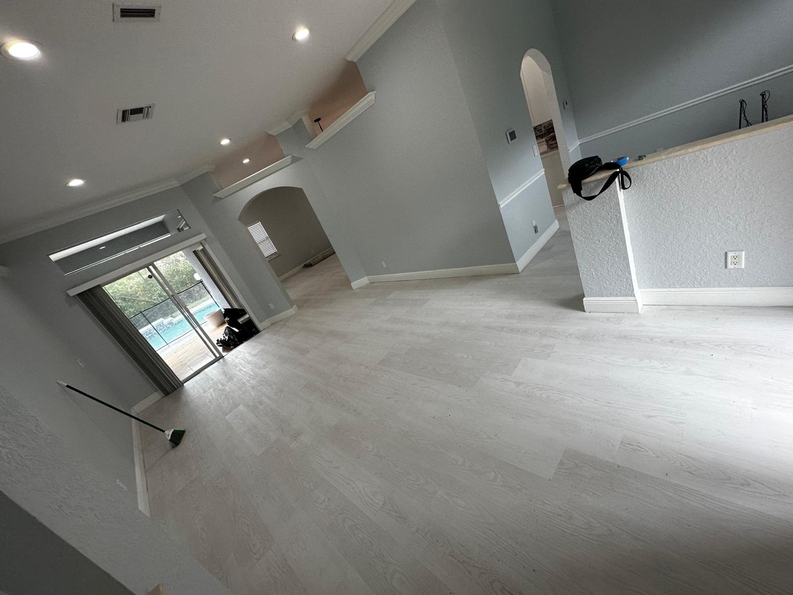 Finished light oak LVP throughout great room with pool view
