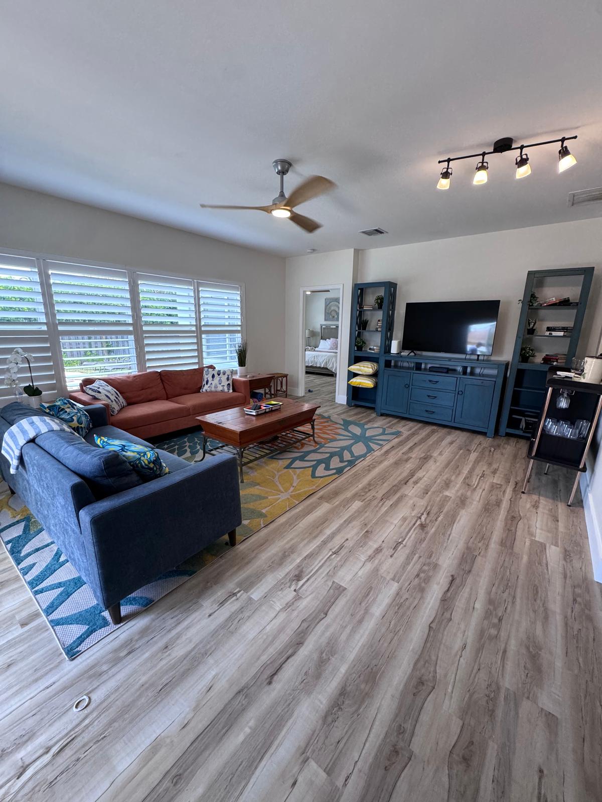 Living room with new wide-plank LVP, sectional sofa and family rug